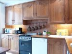 Spacious, fully equipped kitchen with Italian tile floors, marble back splash